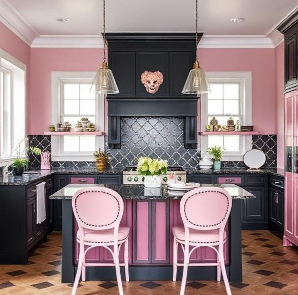 Chic kitchen with pink and black decor, pink chairs, checkered wood floor, pendant lights, plant centerpiece, and a cozy, modern vibe.
