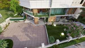 Modern multi-story villa with balcony, green lawn, and paved driveway.