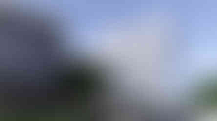 a silver car is parked in front of a building