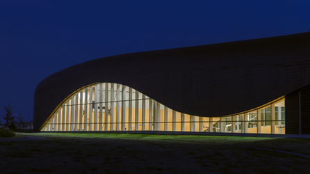 Calgary Architectural Photographer Kyle Graham, an evening photograph of the YMCA exterior with a flowing window shaped like a wave
