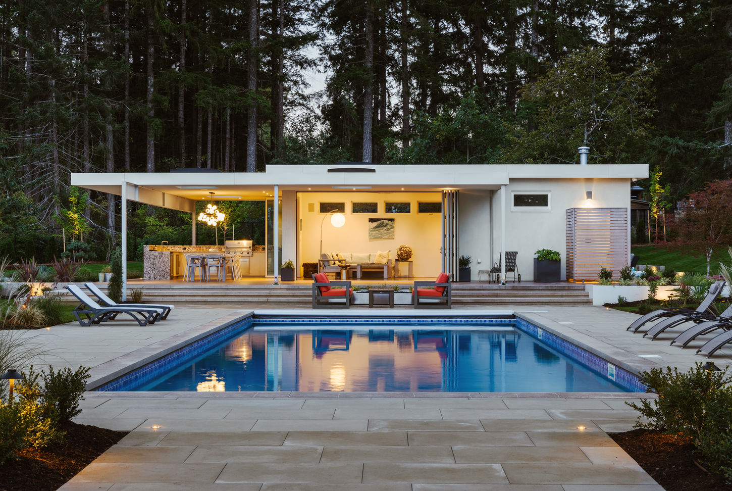 Pool house with a pool in front of it in the comox valley on vancouver island photographed by Design Photographer Kyle Graham