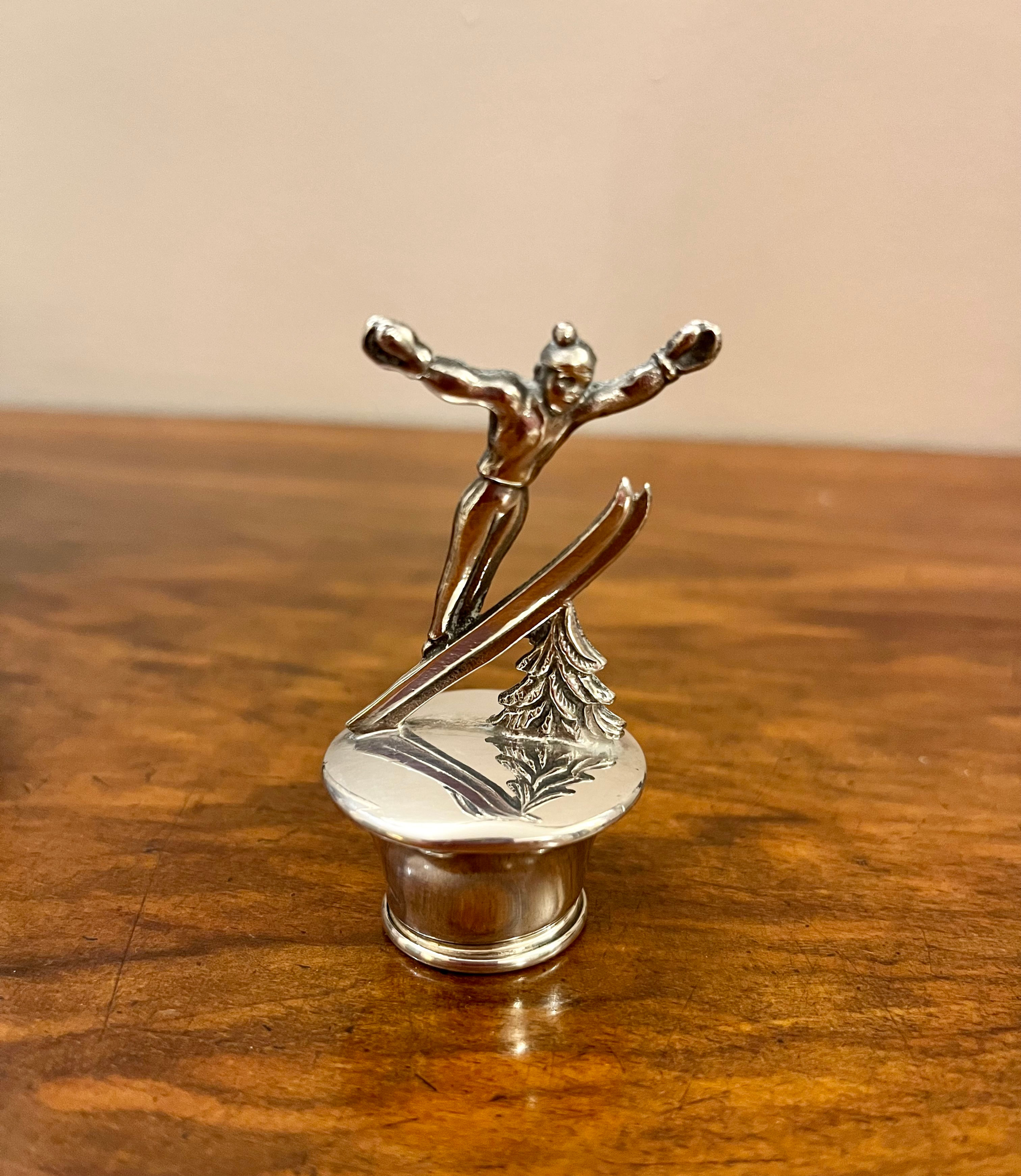 A silver-plated bottle top