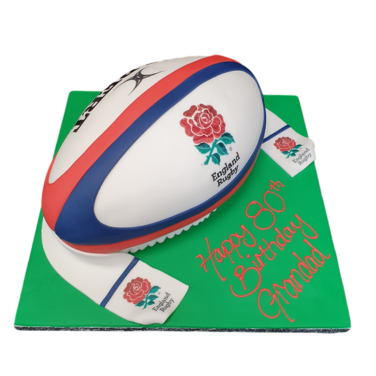 Bespoke England Gilbert rugby ball cake with detailed stitching, displayed for a celebration in Solihull, West Midlands.