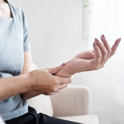 Woman holding her painful wrist