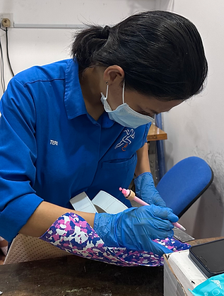 Woman marking fabric for an ankle foot orthosis
