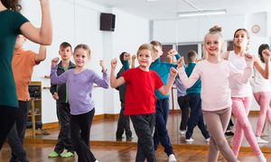 A group of smiling children in a dance class