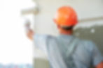 Young painting facade builder worker wit
