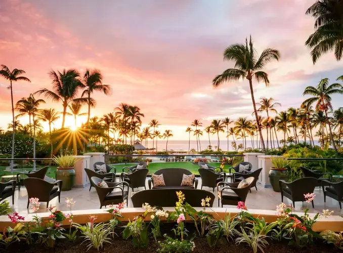 Outdoor lobby at Fairmont Orchid facing a sunset pool and ocean view on Hawaii's Big Island