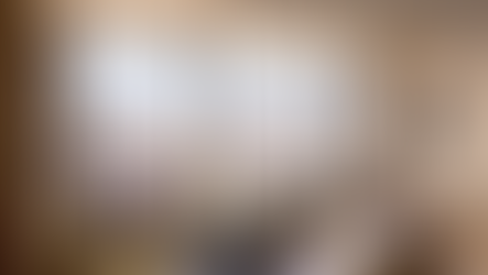 Luxury hotel suite living area with floor-to-ceiling city views, modern furnishings, and designer lighting — representing the upscale segment driving U.S. hotel RevPAR growth amid a widening K-shaped demand divergence in hospitality investment markets.