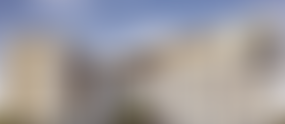 A five-story contemporary multifamily housing development featuring cream stucco and corten steel accent panels, representative of the higher-density residential infill projects emerging from accessory dwelling unit legislation and single-family zoning preemption reform across the United States.