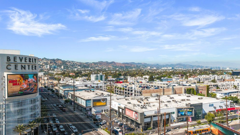 Aerial view of a West Coast commercial corridor illustrating regional construction cost premiums for SBA-financed retail and mixed-use development.