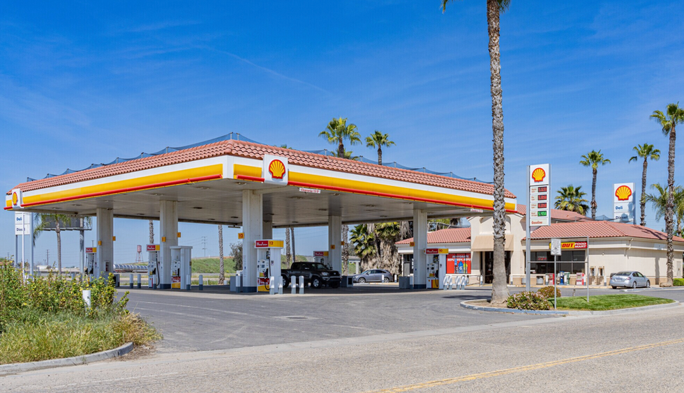Large-format gas station canopy with multi-position fuel islands, convenience store, and monument signage — illustrating commercial fuel retail site plan standards across U.S. markets.