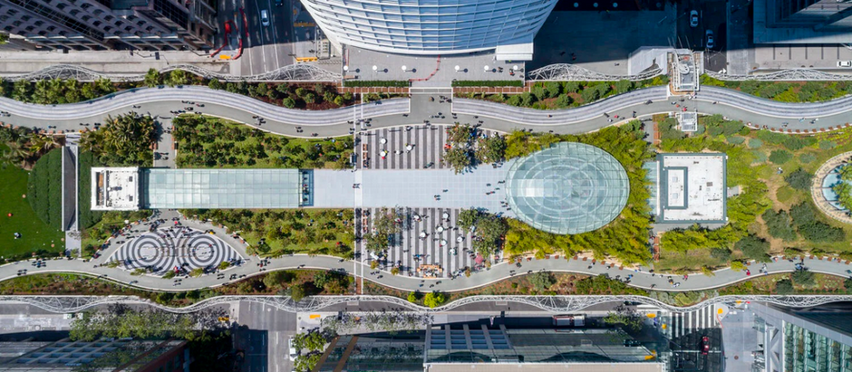 “Salesforce Park rooftop garden in San Francisco with trees, paths, and seating above the transit center.”