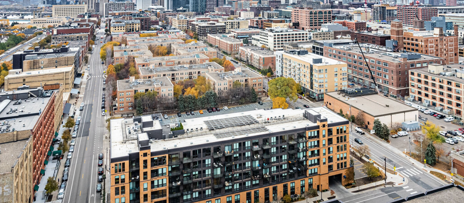 Urban infill district illustrating a vertical warehouse site plan concept in a dense U.S. city, highlighting land constraints, mixed-use surroundings, and the shift toward taller industrial development.