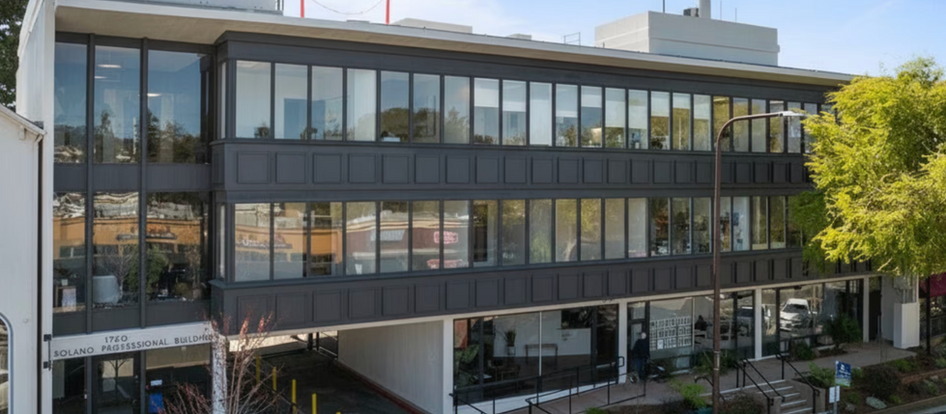 Three-story urban commercial office building at 1760 Solano Professional Building constructed at or near zero front setback, with ground-floor retail frontage built directly to the sidewalk line — illustrating the build-to-line standard common in dense commercial zoning districts across U.S. markets.