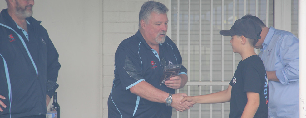Life members Darren and Barry presenting Travis with the club batting award