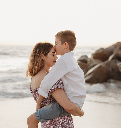 A closup of mother holder her son at sunset at a Perth beach during a Family Photography shoot