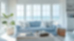 Wide angle view of a cozy coastal living room with various cushions