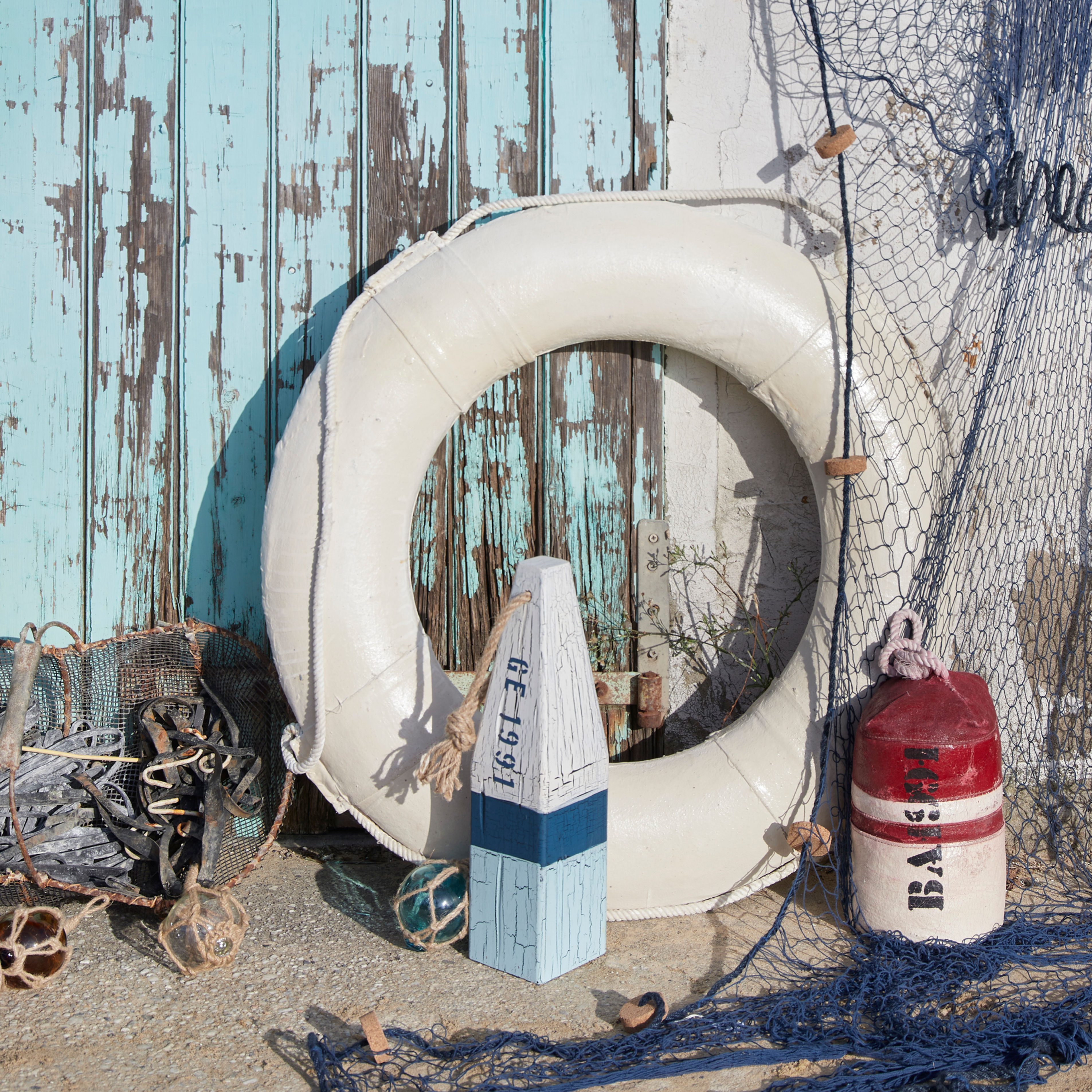 Vintage-style antique white decorative life ring for nautical interiors.