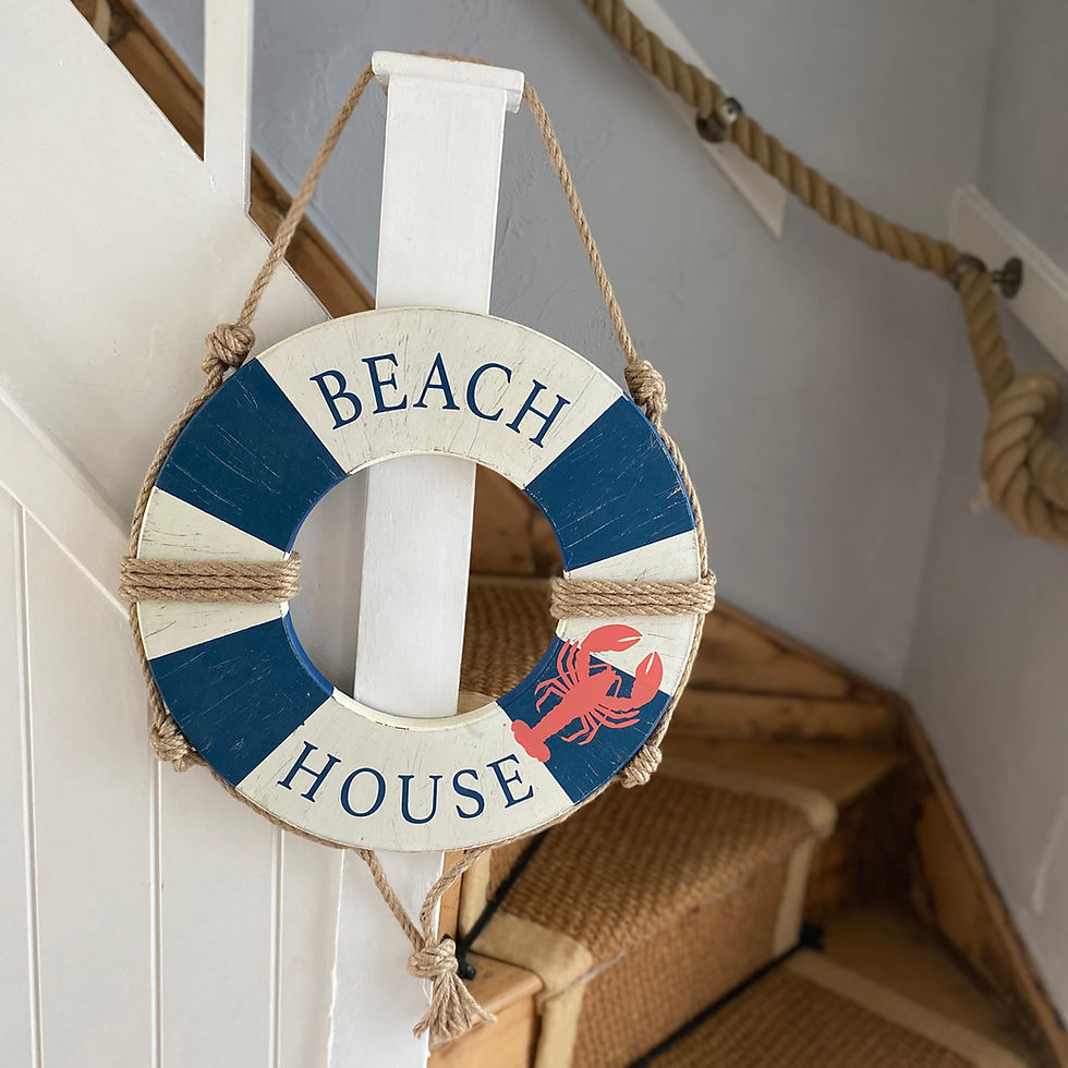 Beach House wooden lifebuoy wall hanging in blue and white with natural rope.