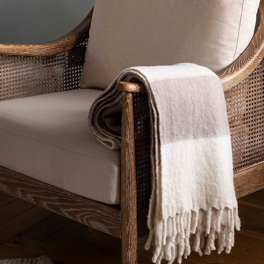 Cove Natural Wide Stripe Wool Throw draped over a coastal style armchair