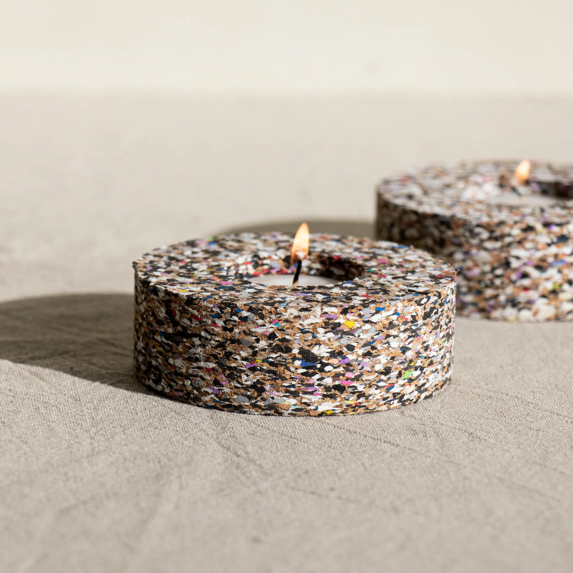 Sustainable speckled tealight holder crafted from beach-clean waste