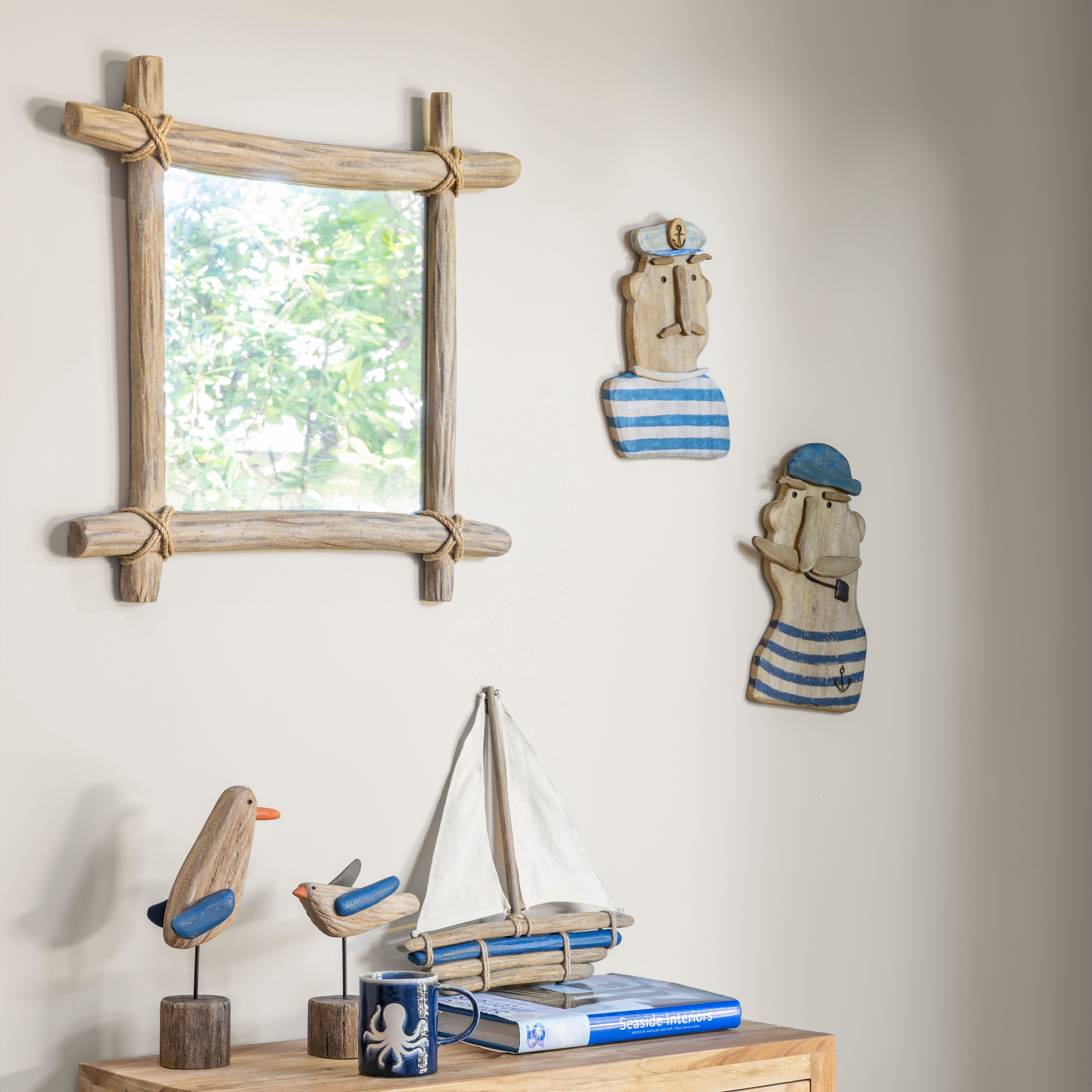 Coastal style interior with square weathered wooden mirror on wall