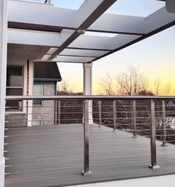 Covered deck corner with stainless cable railing and pergola