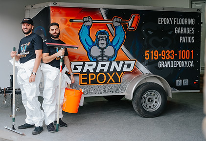 Grand epoxy owners infront of work trailer