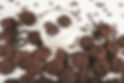 Double chocolate crispy mini cookies next to and in a milk glass.