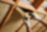 Close-up of hands wearing gloves carefully placing mineral wool insulation between wooden
