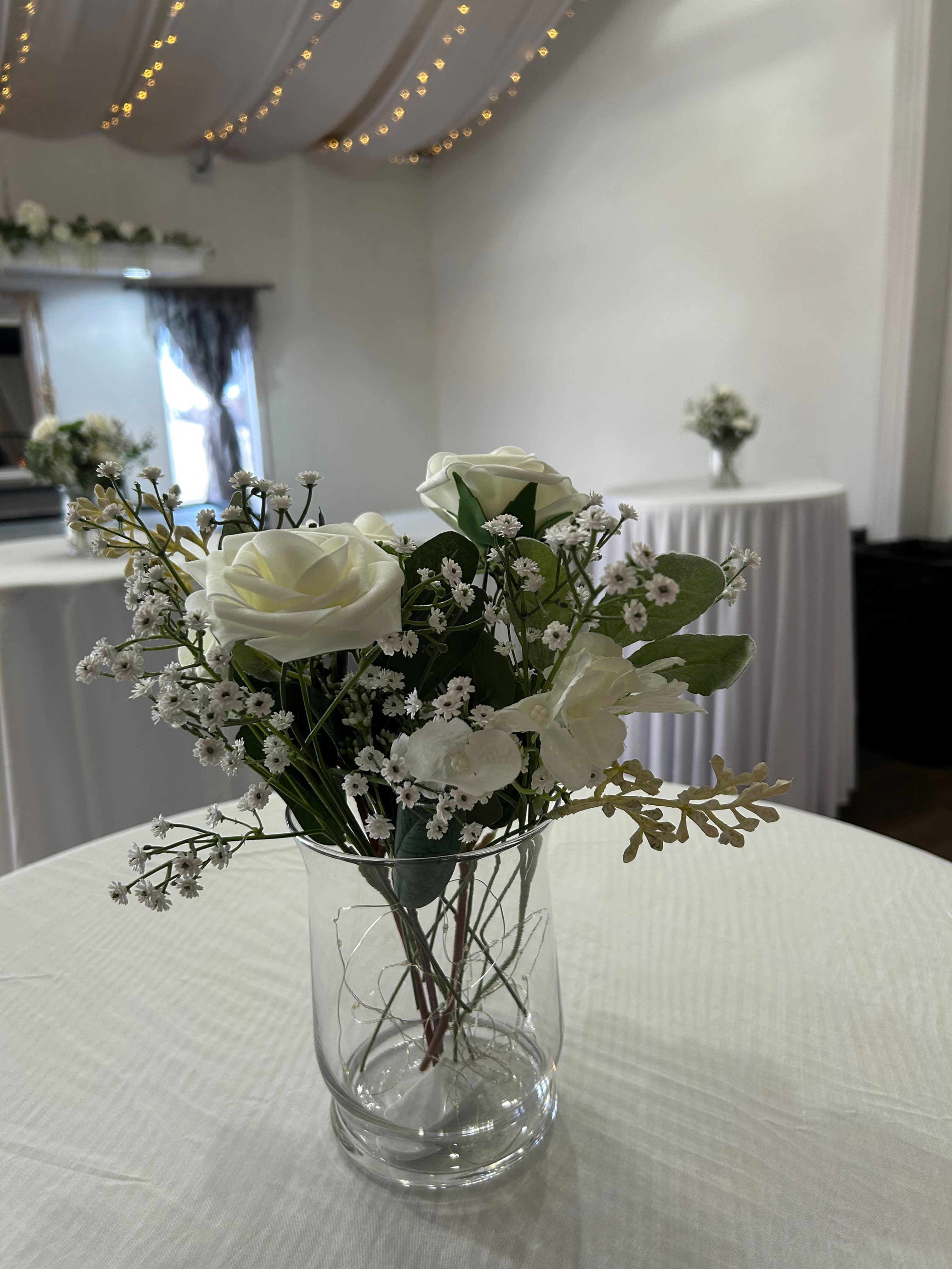12 bigger vases with faux roses and baby’s breath 