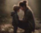 A woman and child gently touch foreheads outdoors. Both wear cozy sweaters in warm light. Peaceful and affectionate moment.