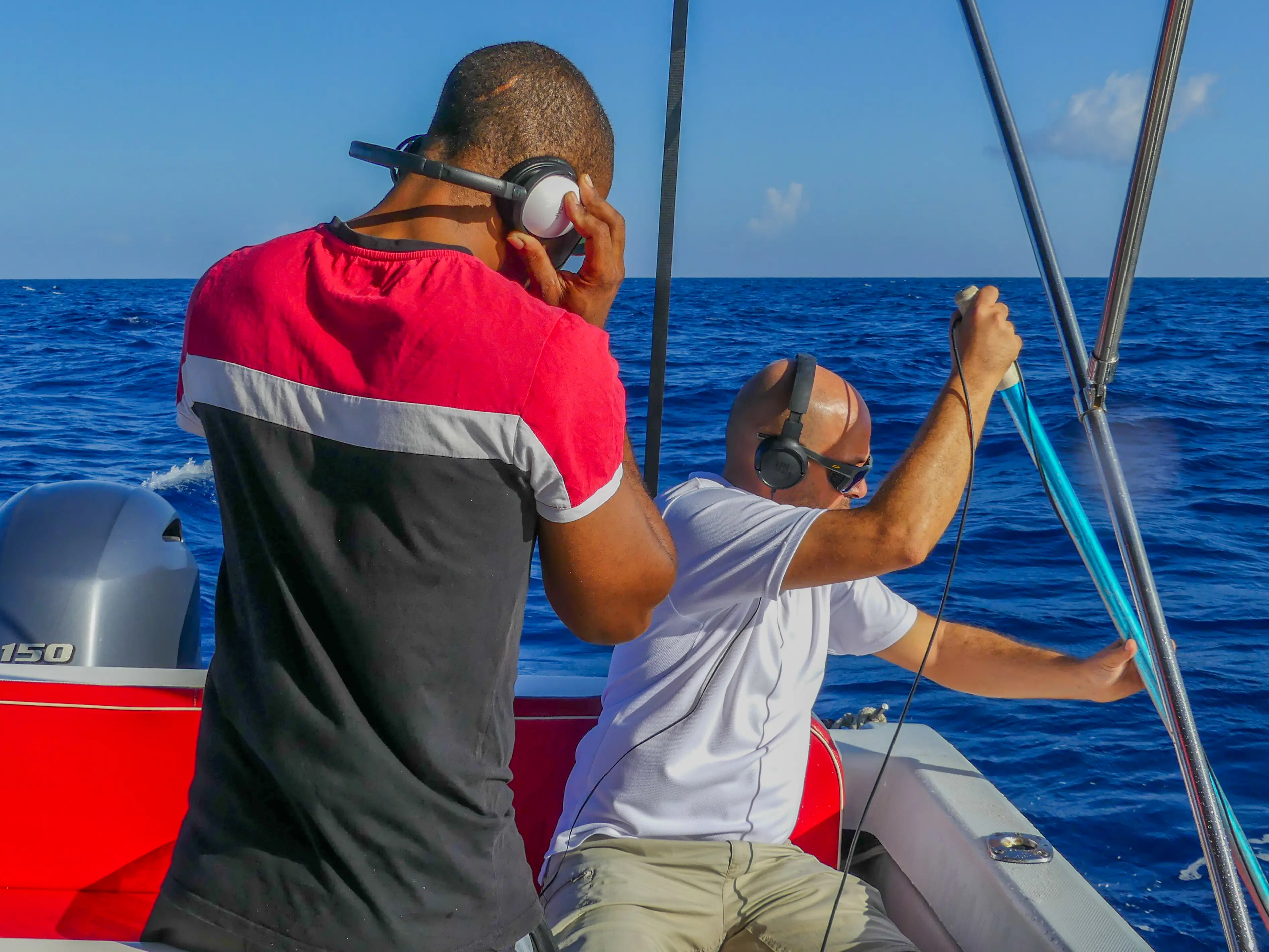 The captain listens to hydrophone sounds to locate cetaceans