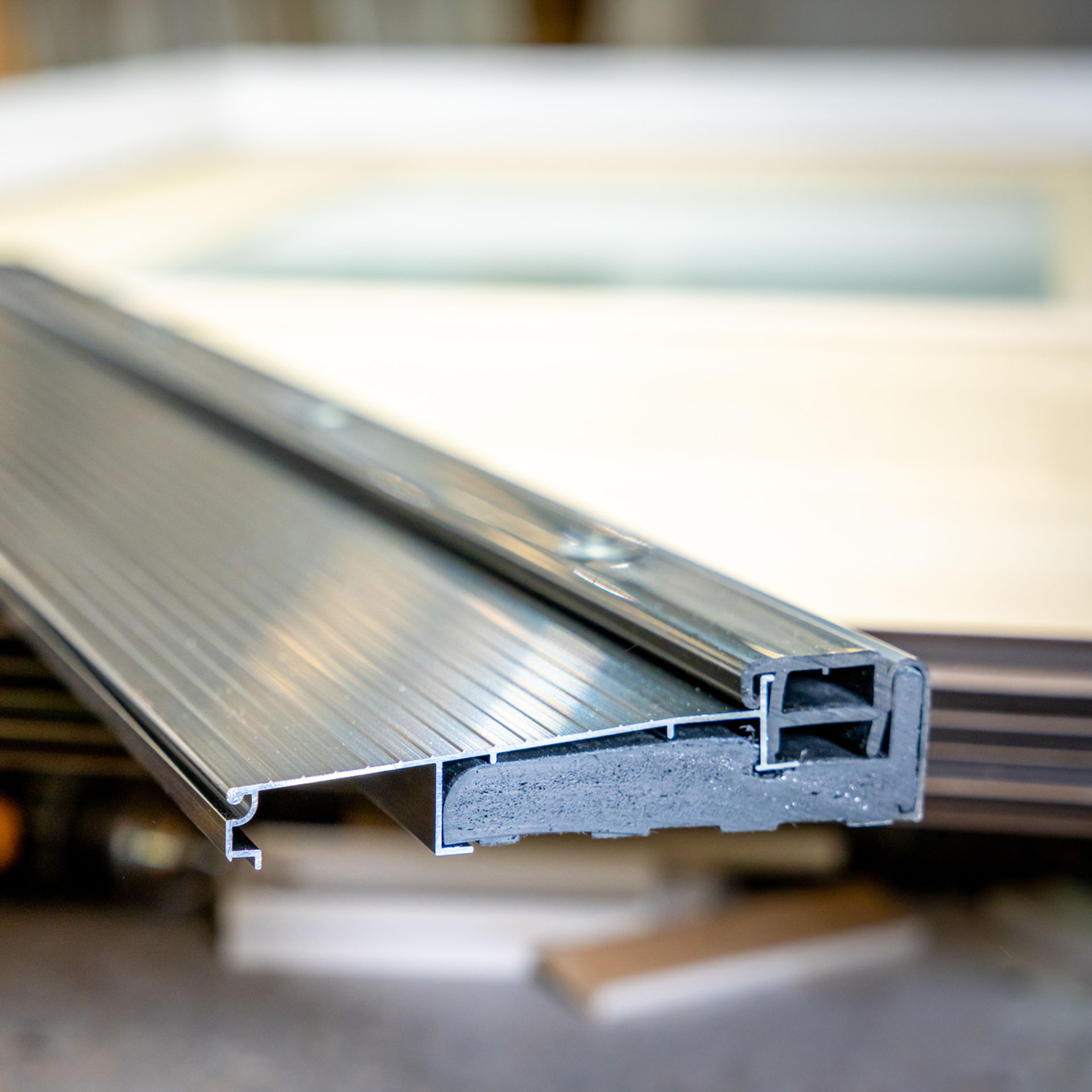 Pile of Flex Series Sills stacked horizontally, showcasing the detailed groove patterns on their surfaces