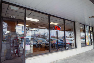 Front entrance and storefront of King Gyros restaurant in Elkhart, Indiana, with large windows and illuminated Open sign.