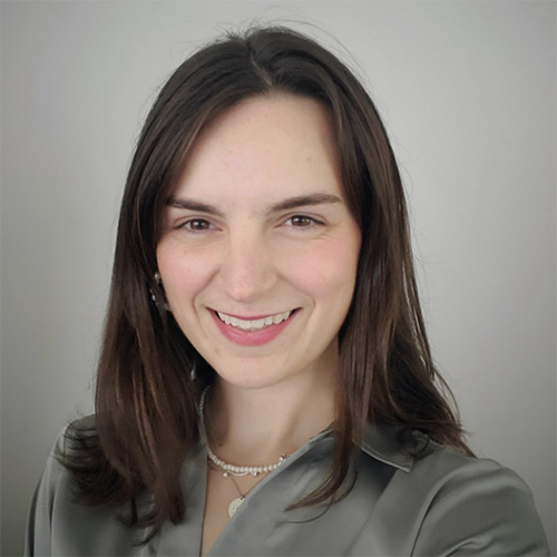 Monsignor Bernie Schmidt gives a blessing at the altar, with candles surrounding him.