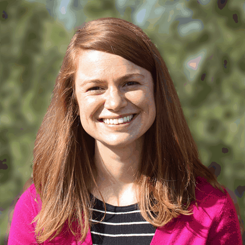 Monsignor Bernie Schmidt gives a blessing at the altar, with candles surrounding him.