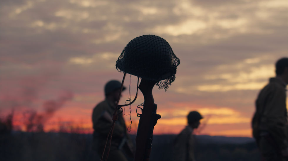 Sunset view of a WW2 helmet on a rifle, cinematic movie film shot