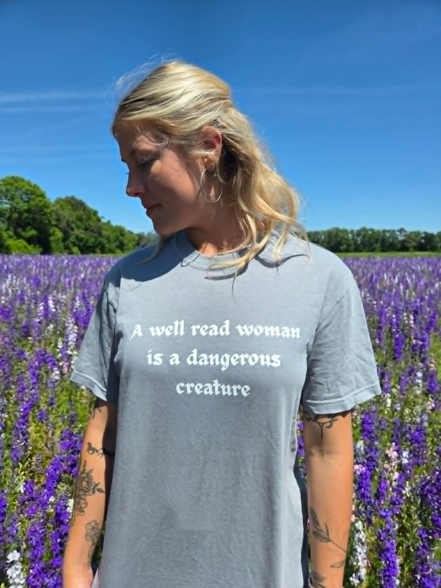 Grey t-shirt with 'A well read woman is a dangerous creature'