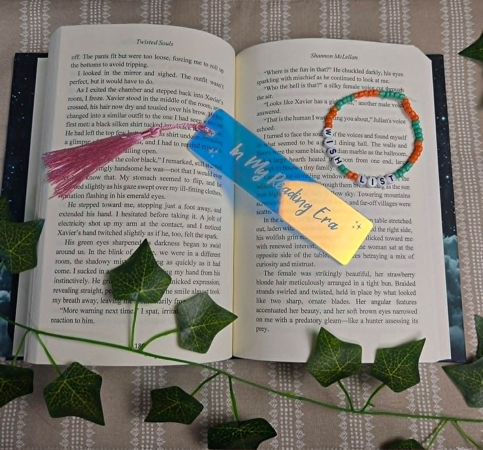 Reading Era bookmark in open book with 'READ' bracelet