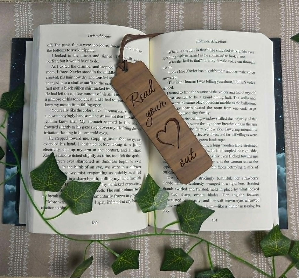 A wooden bookmark with 'Read your heart out' in an open book.