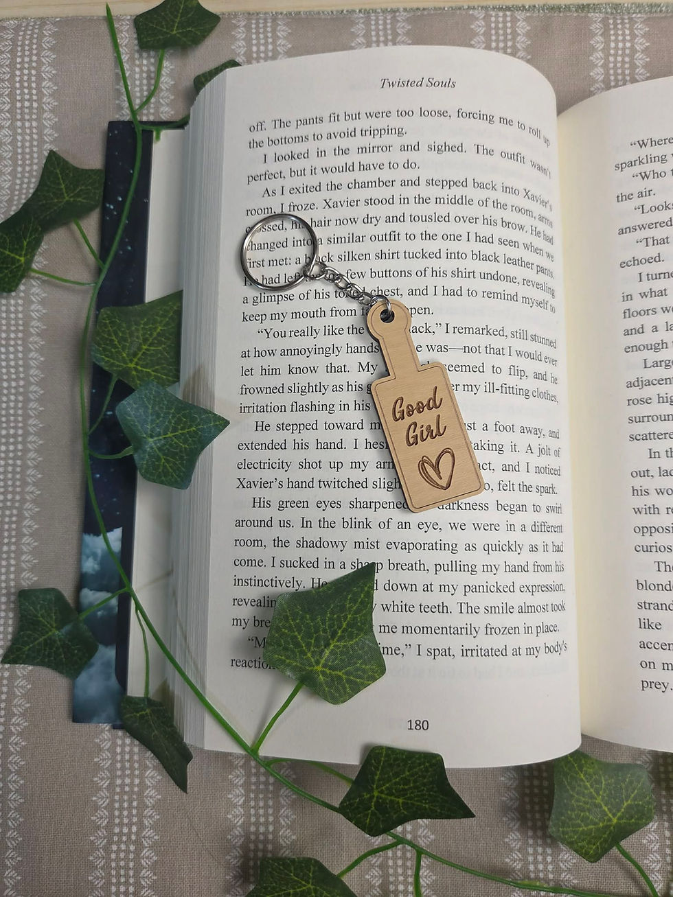 Keychain with 'Good Girl' text on an open book