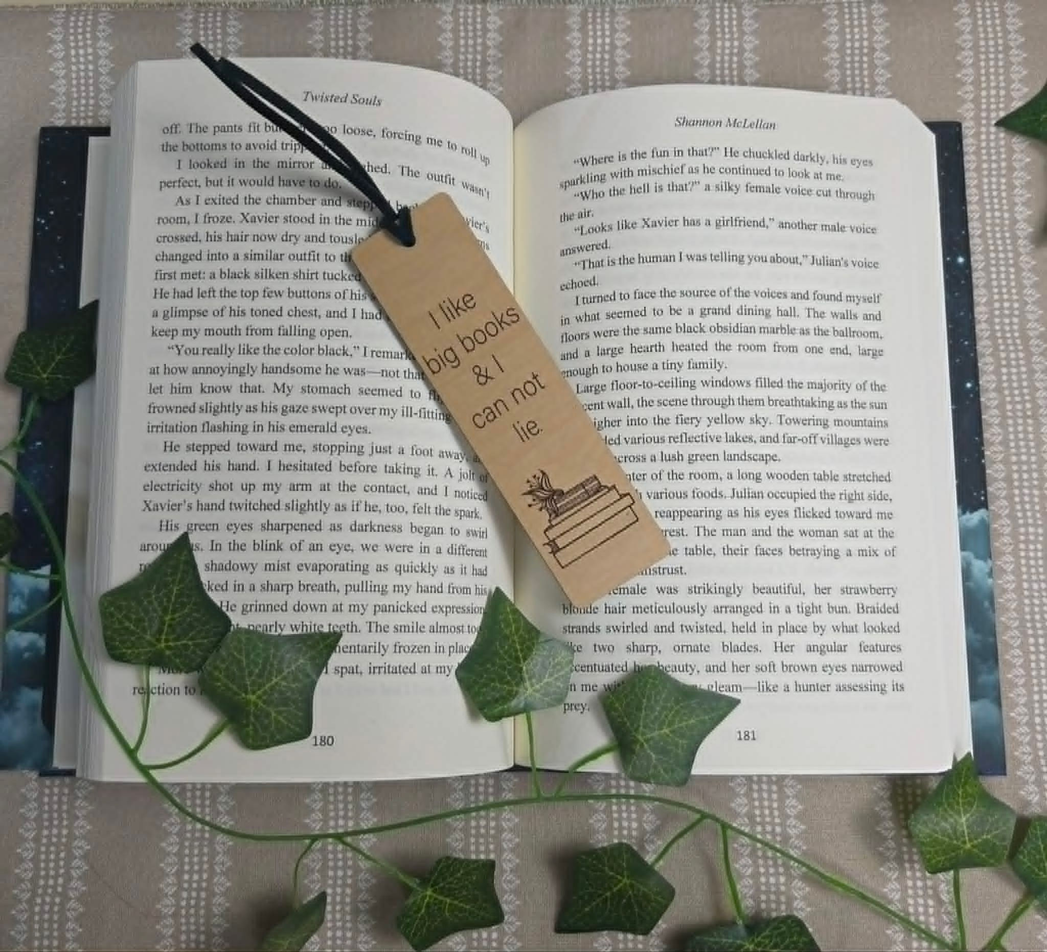 Open book with a bookmark: 'I like big books & I can not lie'