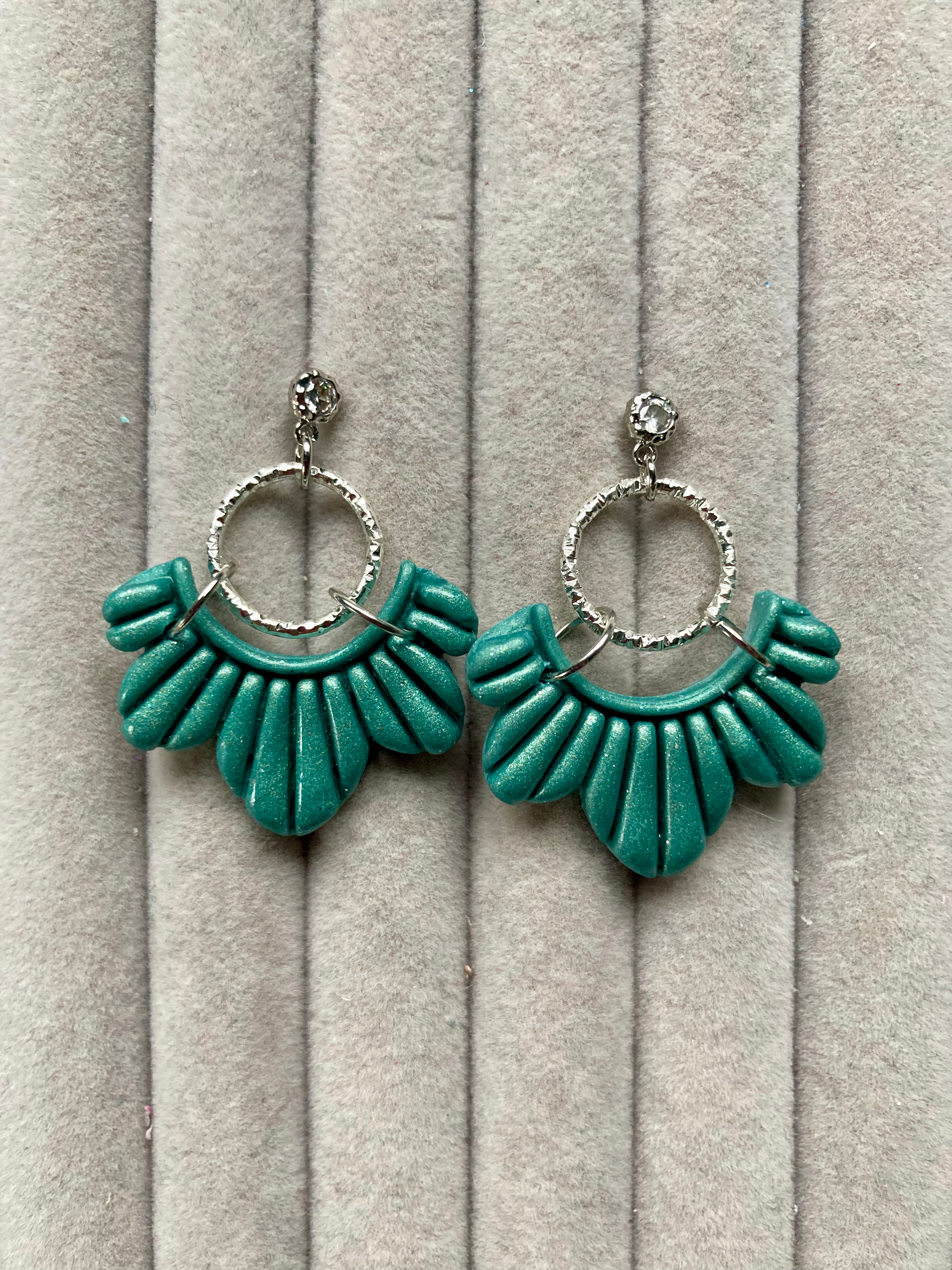 Light green scalloped earrings on textured studs