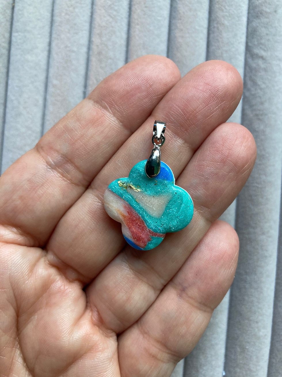 Thumbnail: Blue, green, orange and cream polymer clay and stainless steel pendant