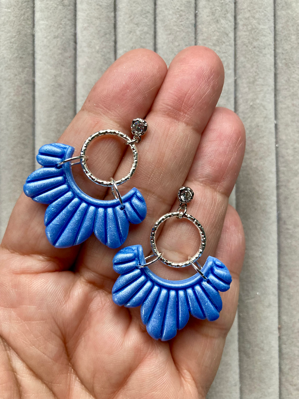 Thumbnail: Light blue scalloped earrings on textured studs