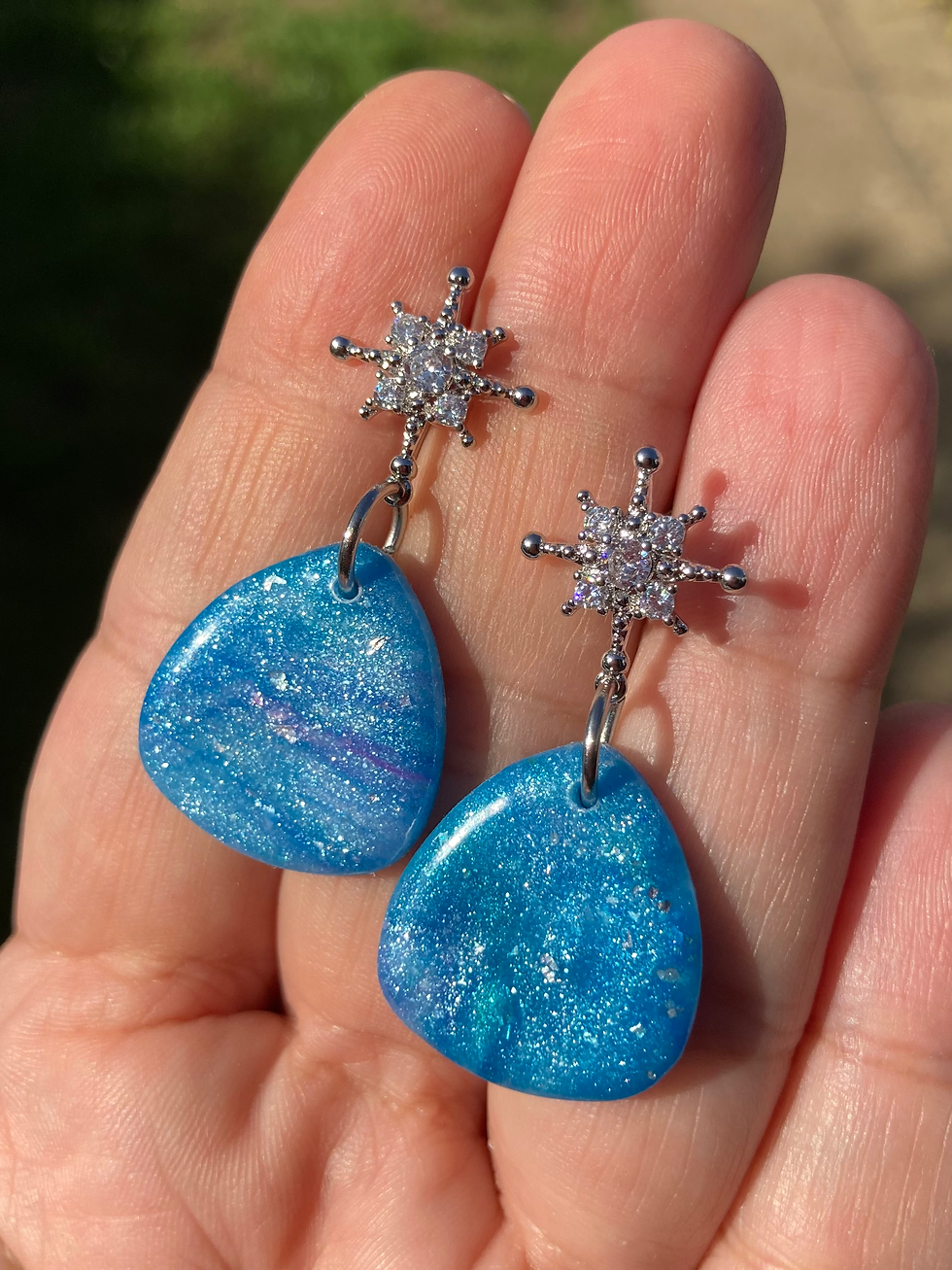 Thumbnail: Marbled blue, purple and green soft triangle earrings on starburst studs