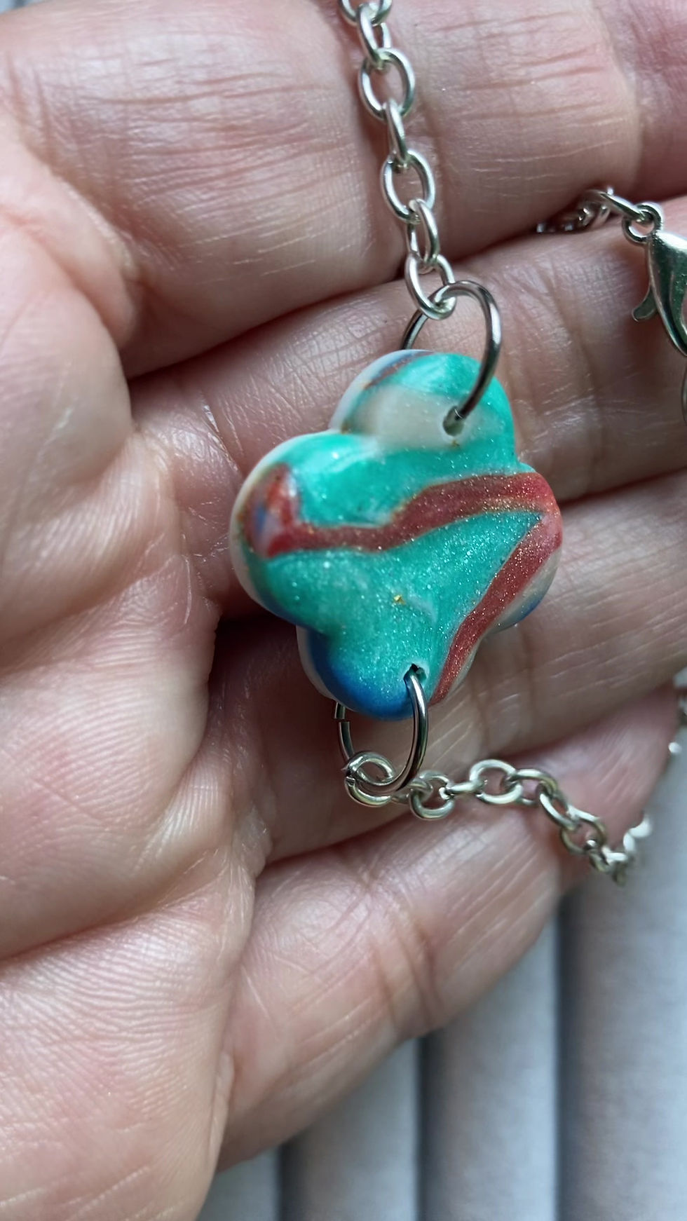 Thumbnail: Blue, green, orange and cream polymer clay bracelet on a silver plated cha