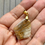 Thumbnail: Marbled bronze and white shield pendant on gold plated fittings